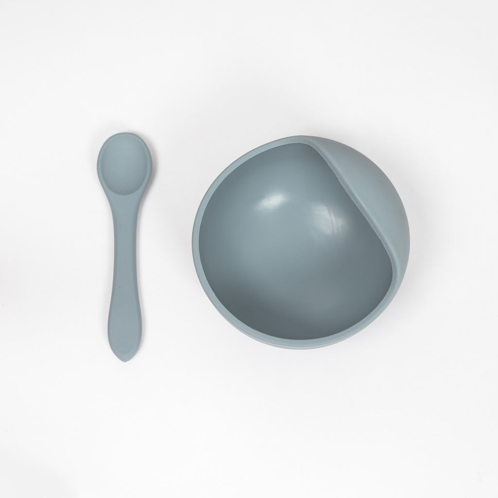 100% safety tested food grade silicone suction bowl and spoon set in pale grey blue. Suction bowl has a curbed upper lip that makes scooping purees easy