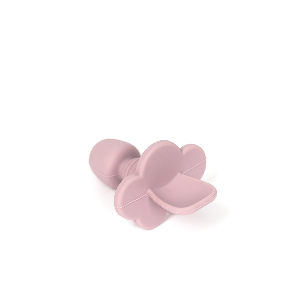 angled image of silicone toddler training spoon in pale mauve. Spoon is made from 100% food grade silicone has a thick short handle to make holding easy and a cloud shaped stopper beneath the soft spoon lip to help prevent gagging as baby learns to eat