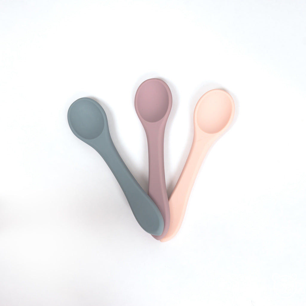 image of three 100% food grade silicone toddler sized spoons in blush mauve and pale blue