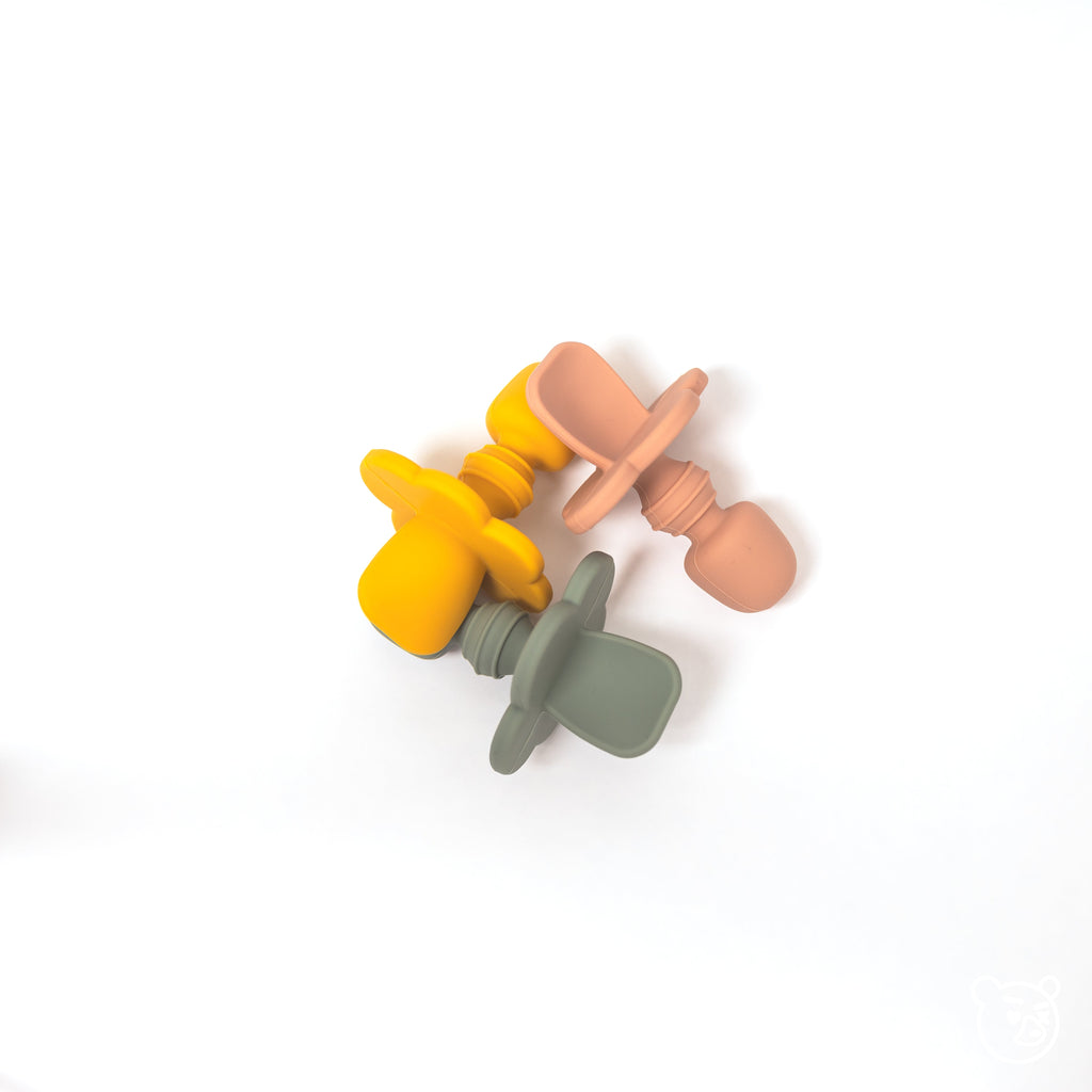 image of three 100% food grade silicone infant spoons in terracotta mustard yellow and sage