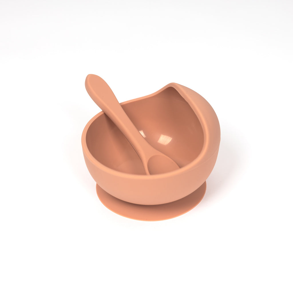 100% food grade silicone set in terracotta. Set includes a toddler sized spoon sitting inside a suction bowl. Curved lip helps make scooping purees easy