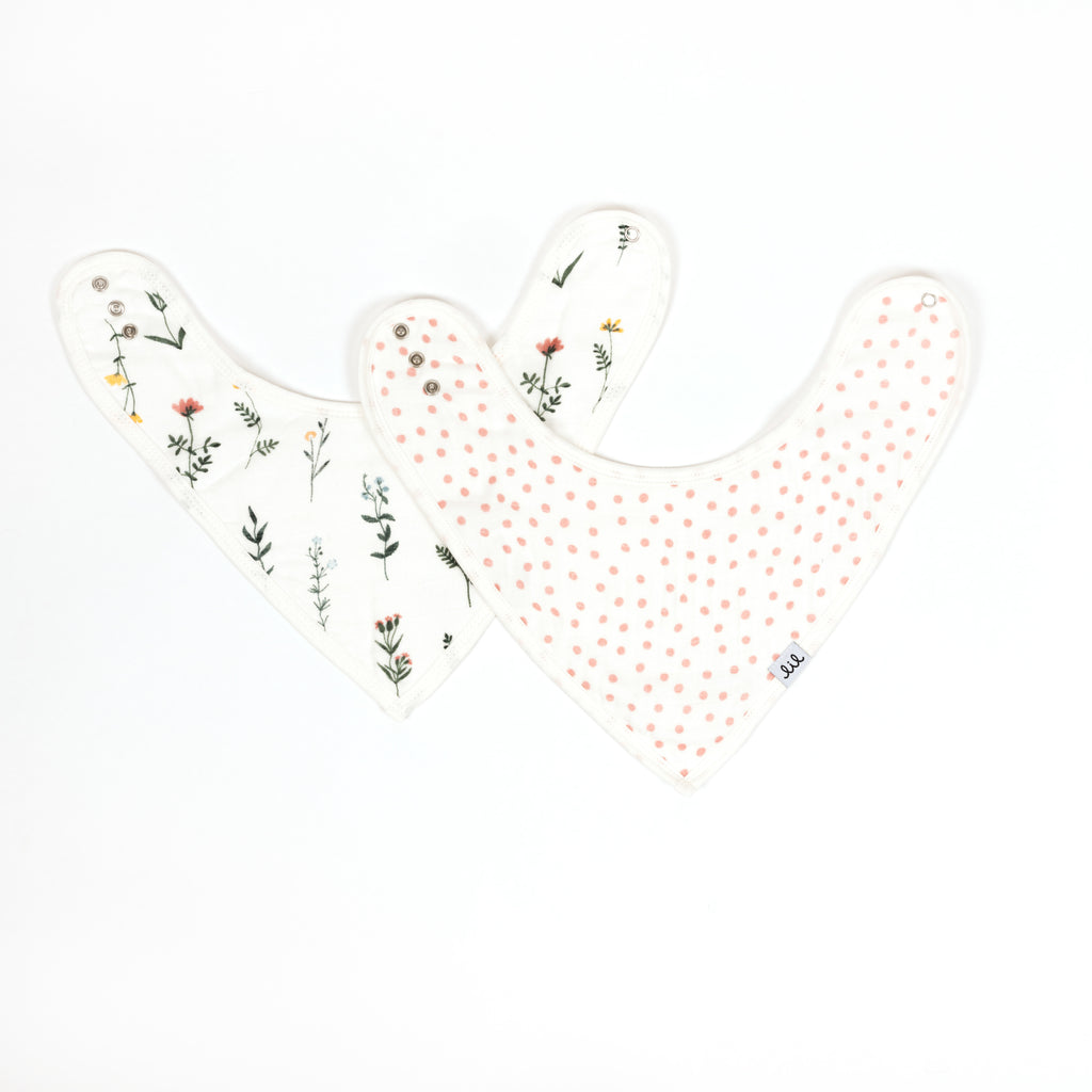 premium set of two bamboo cotton muslin bandana bibs includes one wildflower print with blush periwinkle and yellow florals paired with a blush dot bib