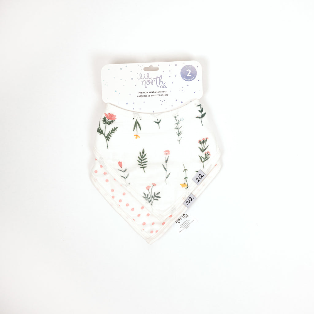 Beautifully packaged set of two bandana bibs with one wildflower print and blush dots print