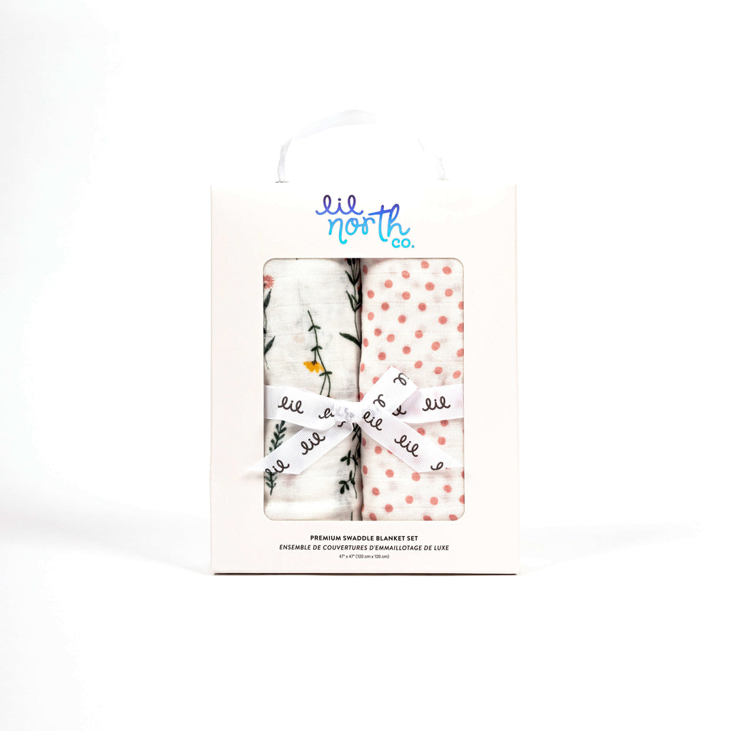 soft swaddle blankets in beautiful white box featuring one wildflower swaddle and one blush dot swaddle blanket