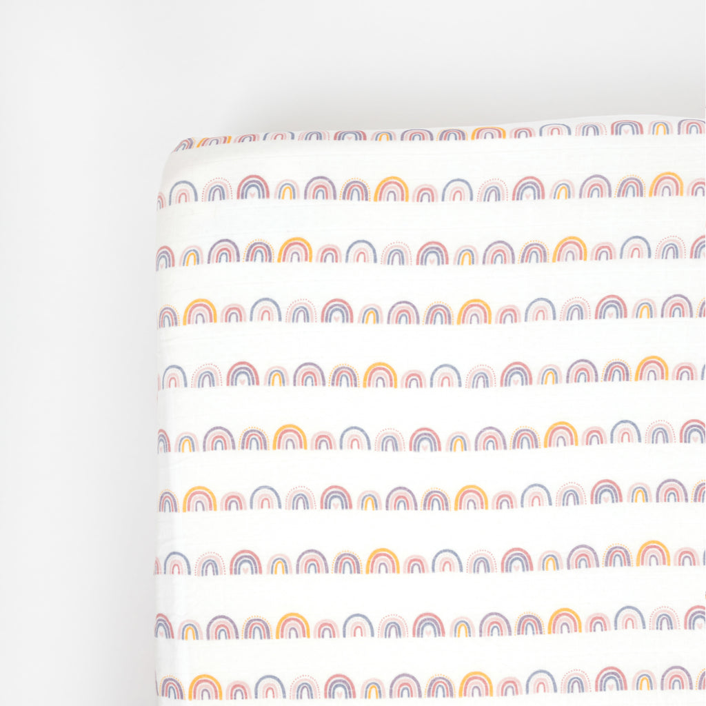 Linear rainbow print with yellow periwinkle lavender and blush colours printed on premium bamboo cotton muslin crib sheet