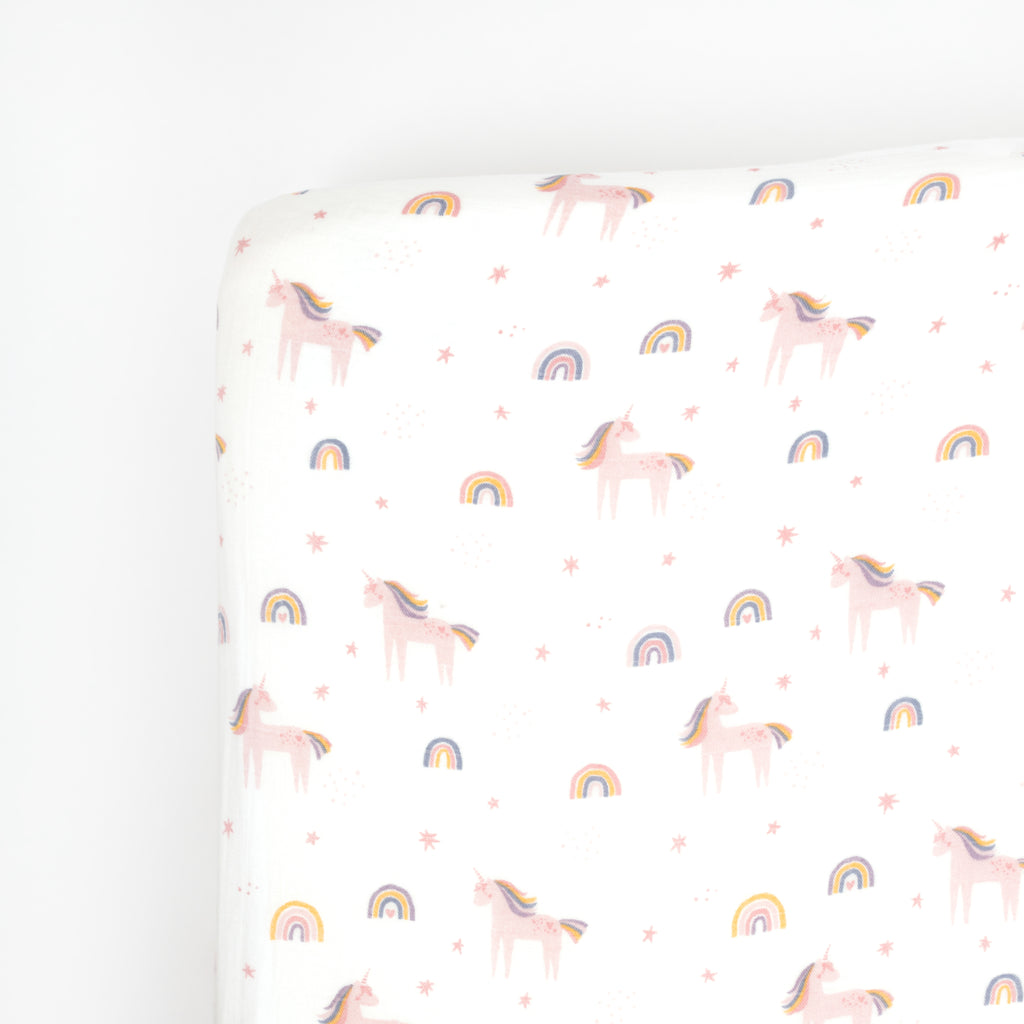 Tossed bright unicorn and rainbows printed on premium bamboo cotton muslin crib sheet.
