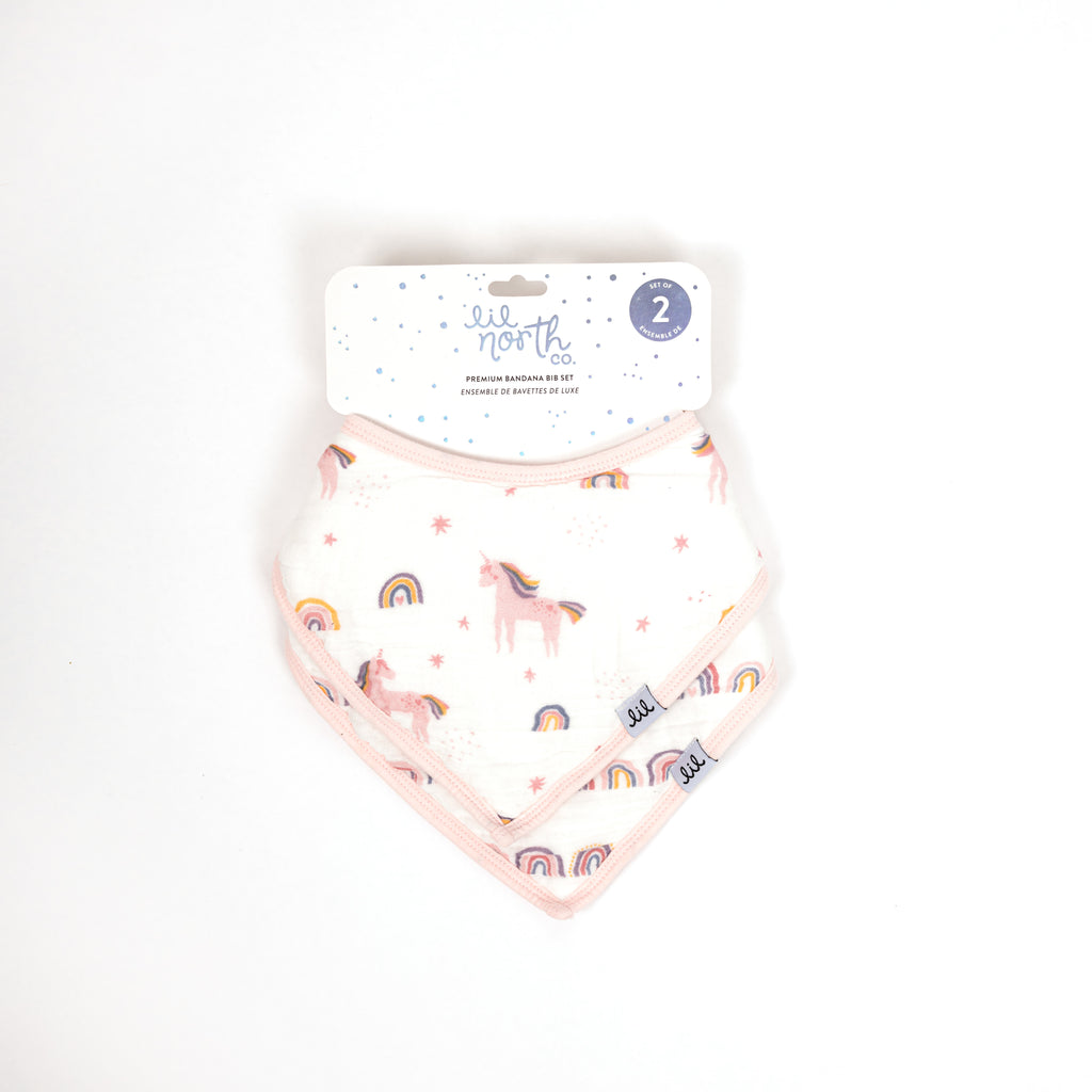 Beautifully packaged premium bandana bibs for newborn or shower gift. This set includes unicorn rainbow toss print and linear rainbow print with blush trim