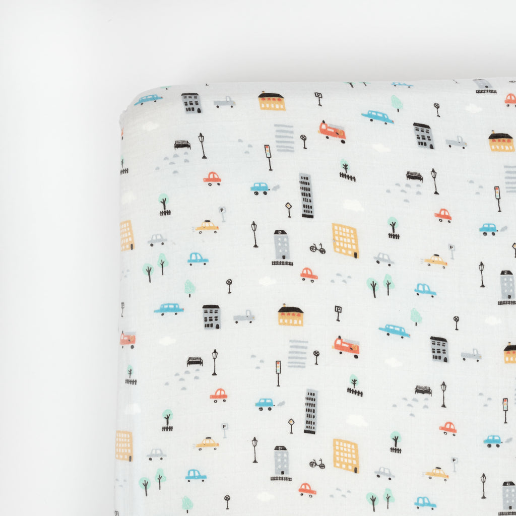 Premium bamboo cotton muslin crib sheet, grey ground city cars print with blue yellow and red cars amongst grey and black buildings and street signs