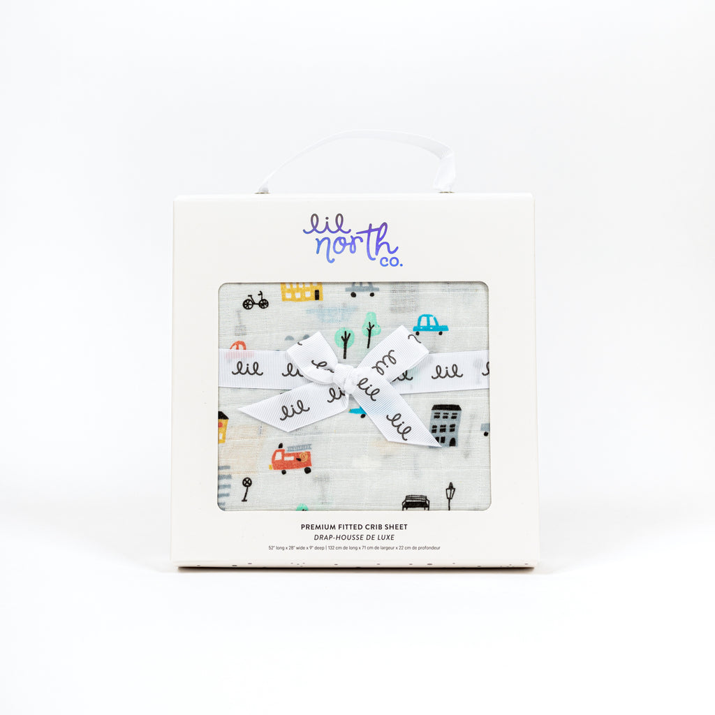 Beautifully boxed crib sheet with city cars print on grey ground