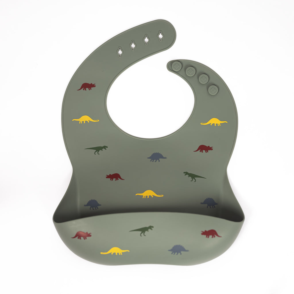 Safety tested silicone bib in sage with tossed dinosaurs in yellow, green, grey and red
