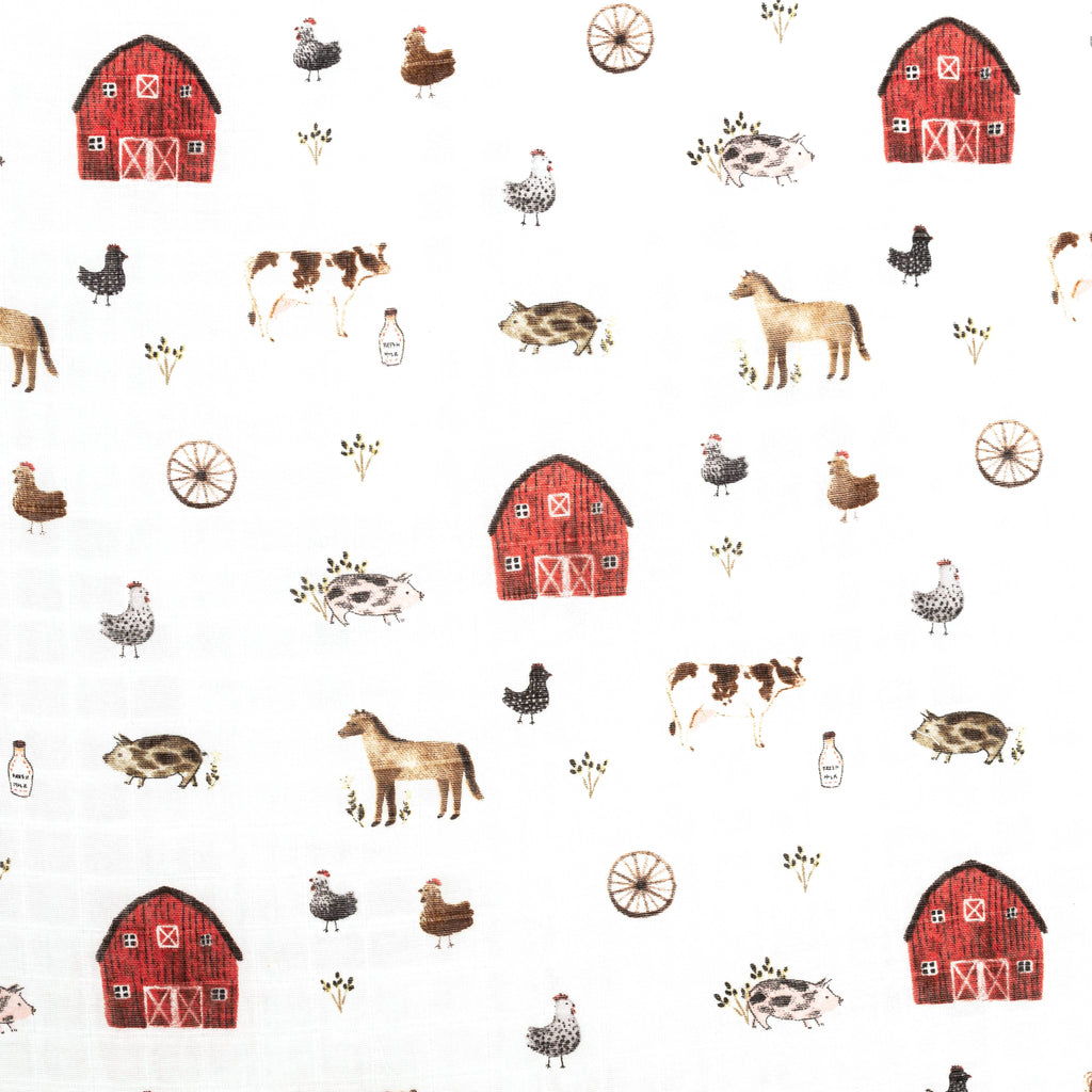 close up image of farm animals crib sheet with red barn and various farm animals on muslin