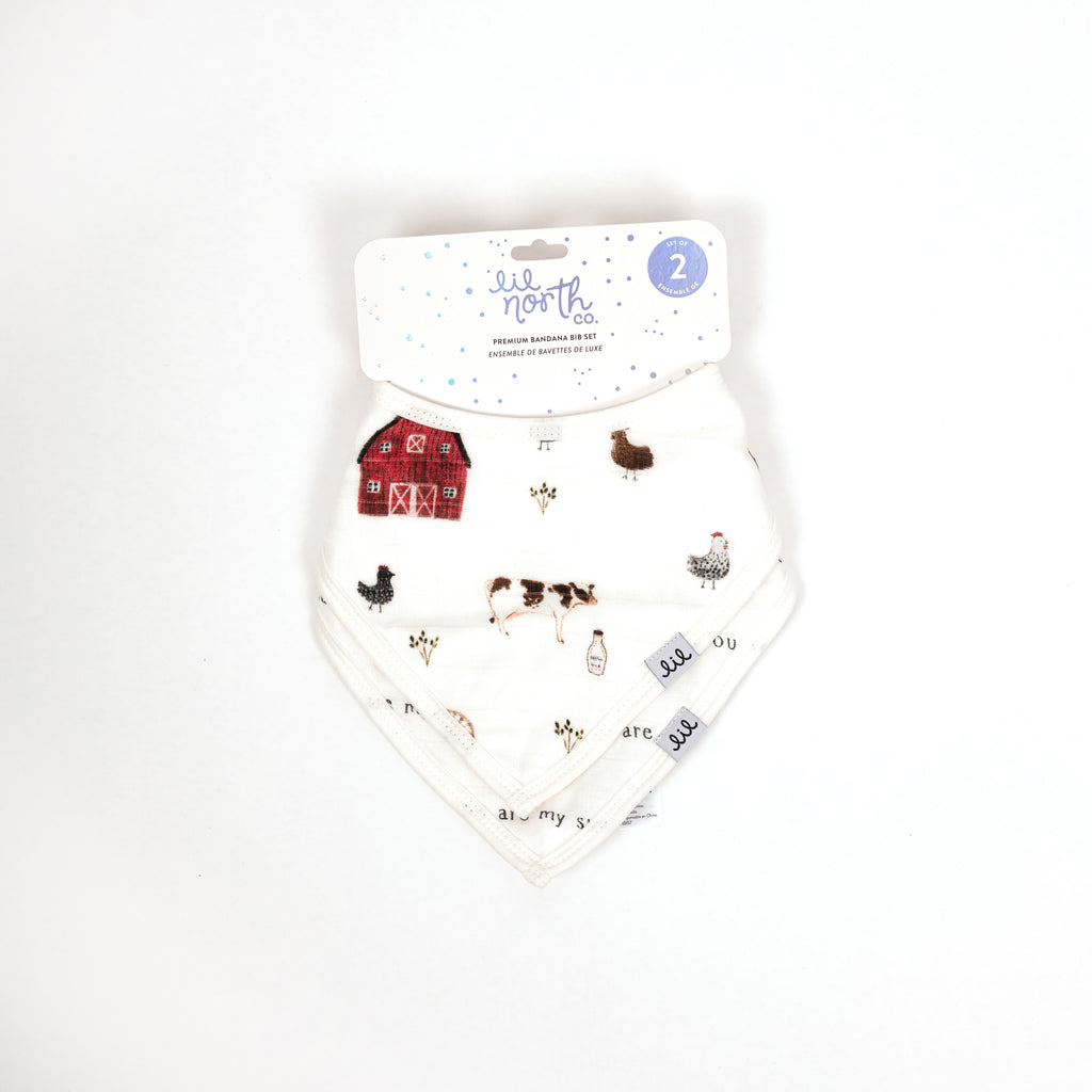 Beautifully packaged gender neutral set of two premium bandana bibs. Set includes one farm animal print  and one you are my sunshine bib