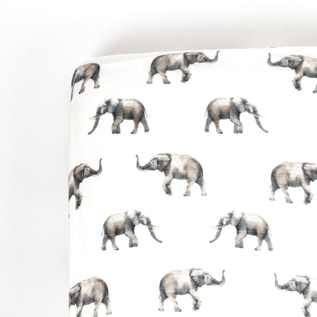 corner image of premium bamboo cotton muslin crib sheet with grey watercolour elephant print