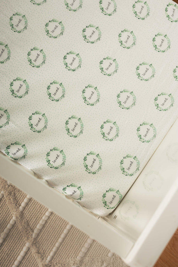 Lifestyle image of sage and green watercolour foliage wreath with loved in the middle of this crb sheet.  