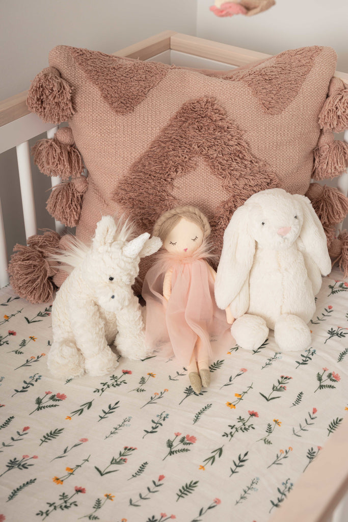 Image of boho wildflower muslin crib sheet in babyletto scoot crib. Styled with jellycat elephant stuffed animal and blush pillows