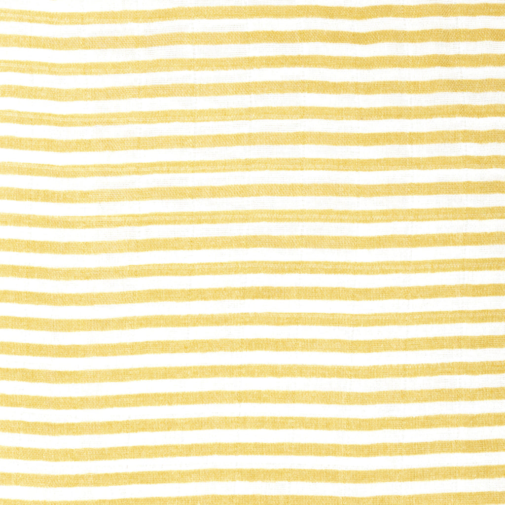 close up image of ochre and white muslin crib sheet