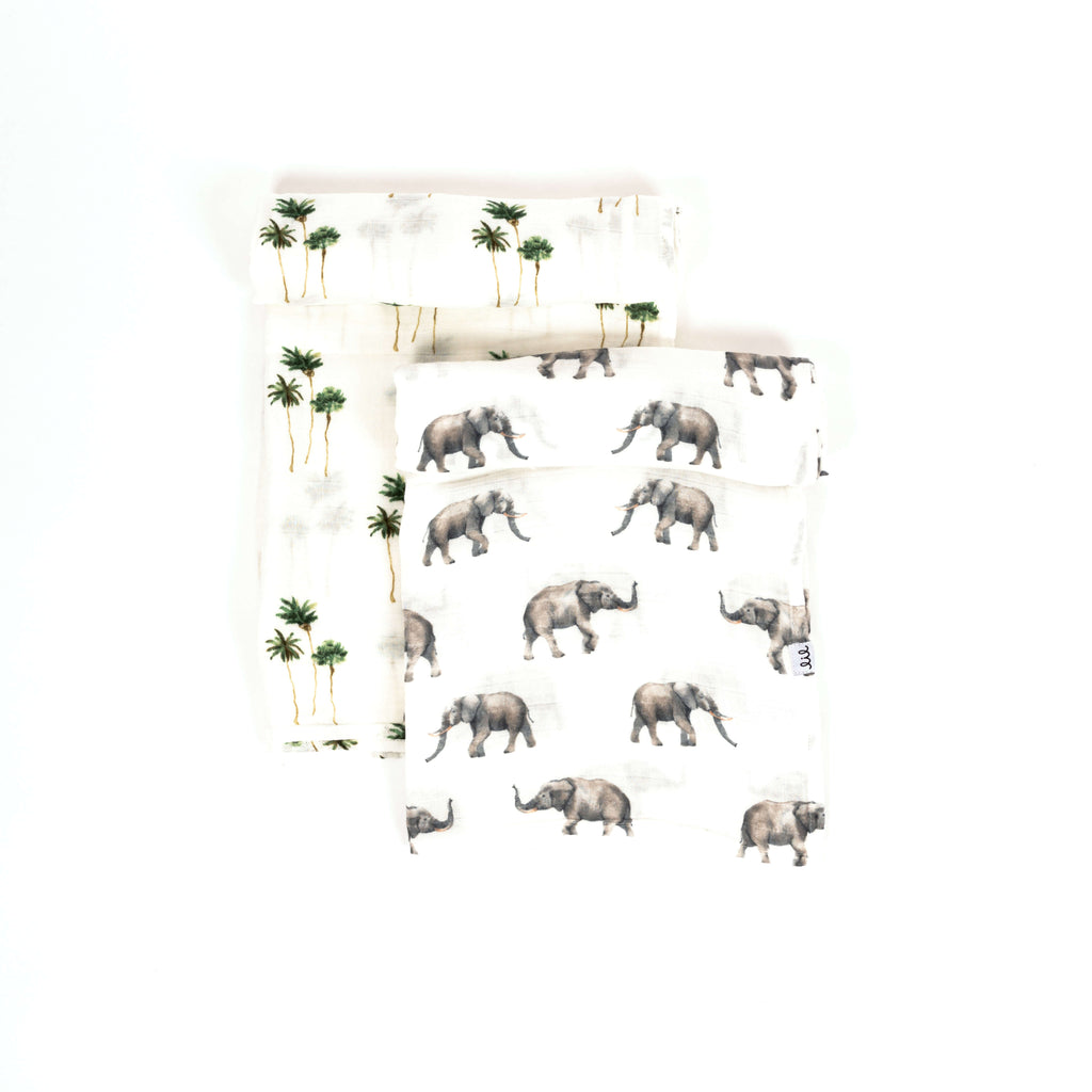 Safari swaddle set with one grey elephant print and one green and brown palm tree print. PErfect for a gender neutral nursery