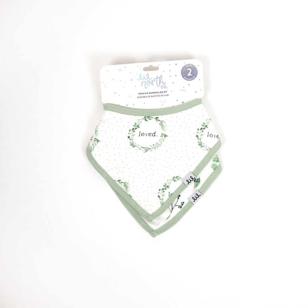 Beautifully packaged set of two bandana bibs includes a sage and green foliage print and a loved wreath with sage dots print